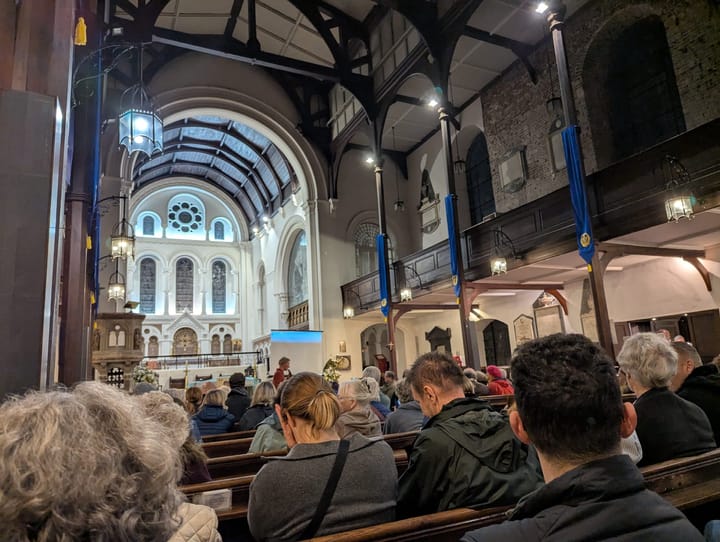 Lit up nave, attendees of the meeting at St Mary's church. 