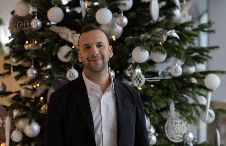 Zack Polanski standing in front of decorated Christmas tree at City Hall.