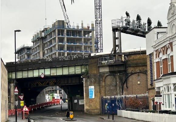 Trundley's Road with construction sites in background. School visible on left. 