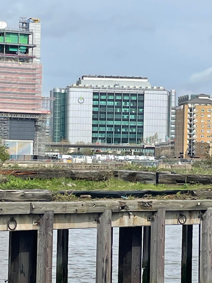 Global Switch datacentre seen across water at Canary Wharf, part of Telehouse datacentre visible on its left